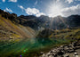 Fine Art Print des Schönrinnenkarsee in den Alpen Österreichs in Gries mit Sonnenstern und dramatischen Wolken, im See spiegelt sich das Ufer