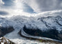 Fine Art Print Blick auf den Gornergletscher mit dramatischer Wolkendecke und Sonnenstern zwischen den Wolken